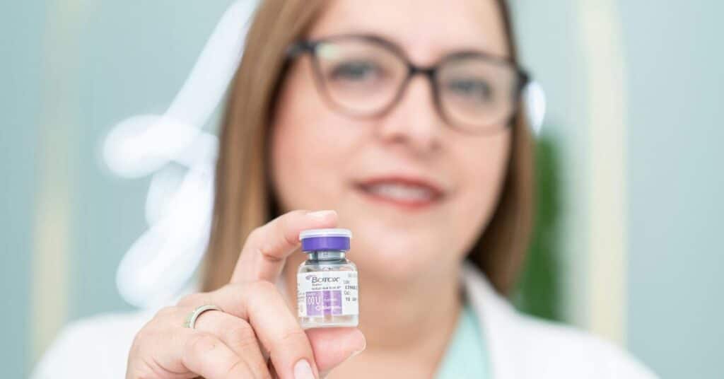 woman-doctor-holding-a-small-botox-vial-slightly-out-of-focus