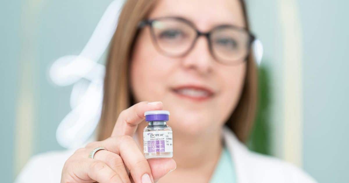 woman-doctor-holding-a-small-botox-vial-slightly-out-of-focus