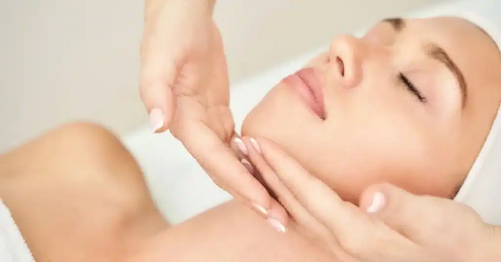 woman-enjoying-a-relaxing-sculptra-facial-massage-at-spa - face - massage - skin-care - therapy - Sculptra
