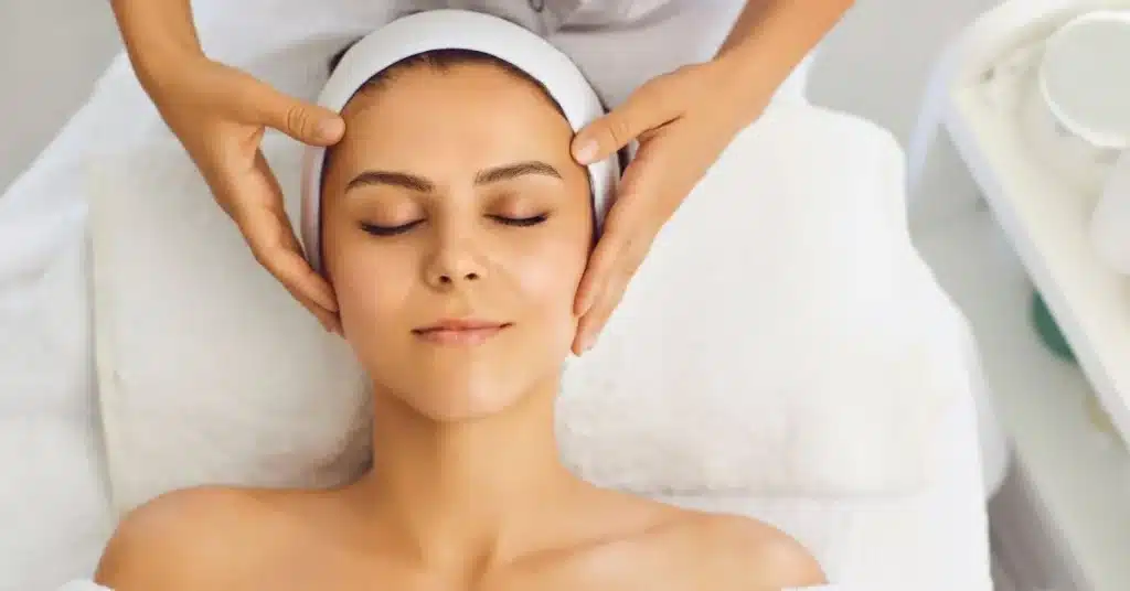 woman-receiving-head-and-neck-massage-during-relaxing-sculptra-facial-treatment - facial - massage - calm - therapy - Sculptra